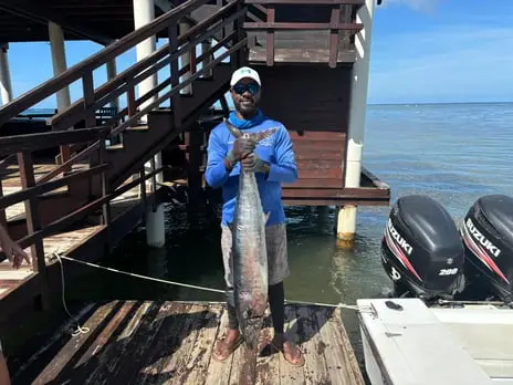 Captain Julio with large Wahoo on the dock, deep sea fishing Roatan, private boat charter, Caribbean adventure, Dos Reyes Roatan