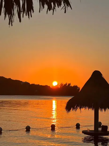 Beautiful Roatan sunset over the Caribbean Sea viewed from a private Dos Reyes Roatan boat charter