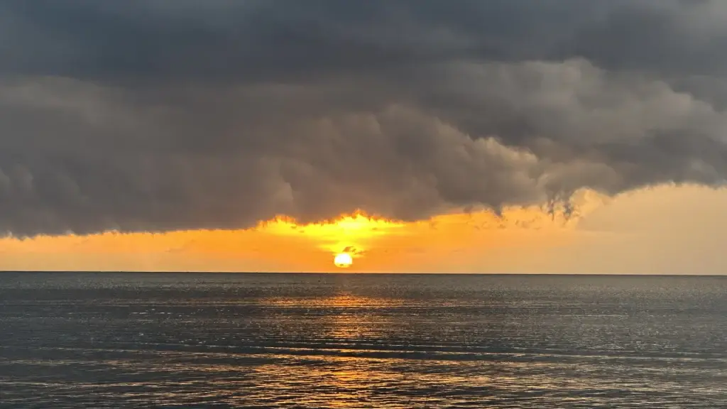 Beautiful magical sunset over the Caribbean Sea — golden sun dipping below clouds with vibrant colors viewed from Dos Reyes Roatan Charter boat