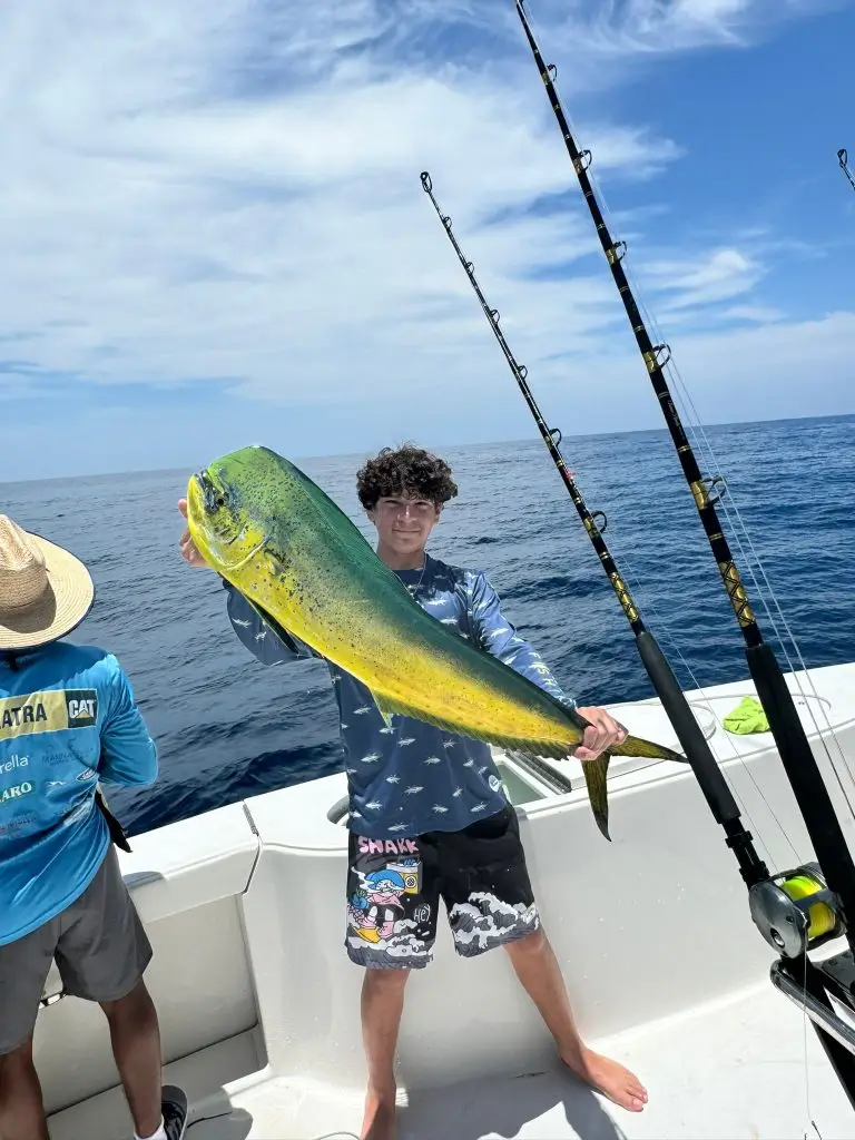Guest’s son with a huge Bull Mahi Mahi aboard Dos Reyes Roatan — #1 private fishing charter in Roatan, Honduras for deep sea and sportfishing adventures