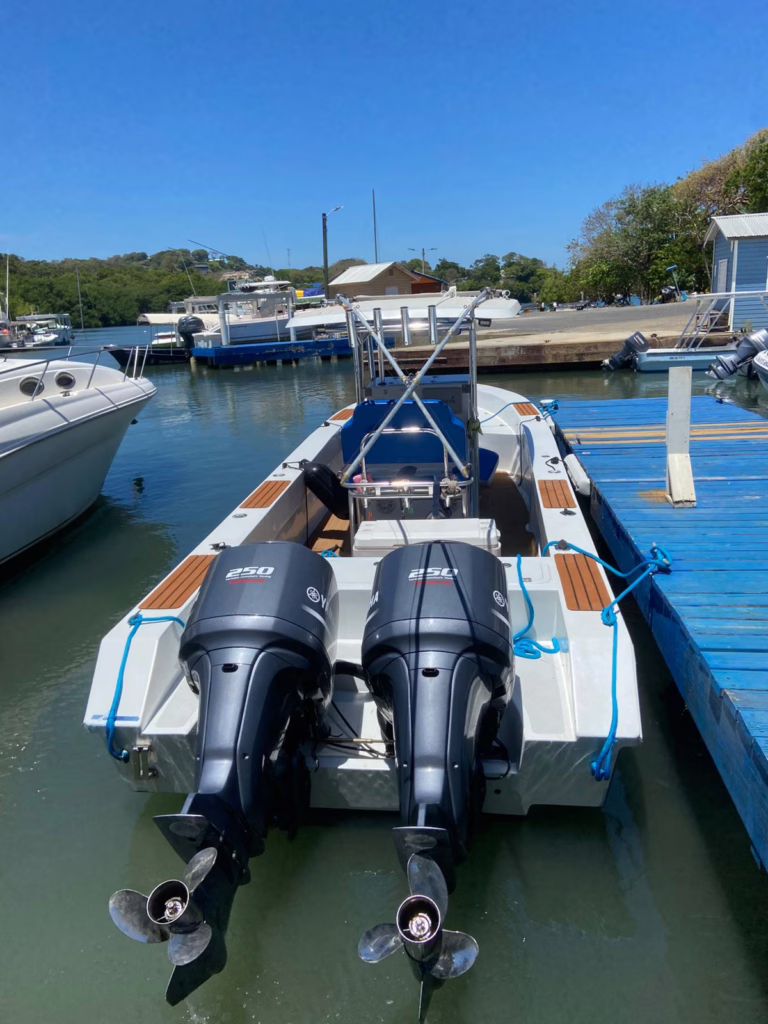 Twin commercial Yamaha 250 HP outboards powering Dos Reyes Roatan — reliable engines for private Caribbean boat charters, fishing trips, and island tours